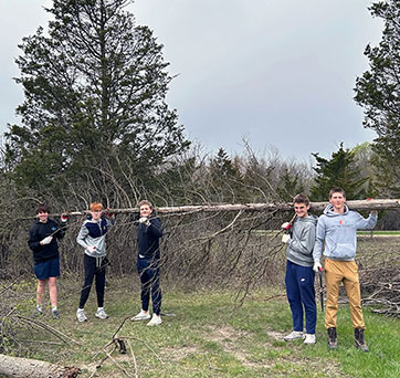 Students holding up a tree. Links to Gifts That Protect Your Assets