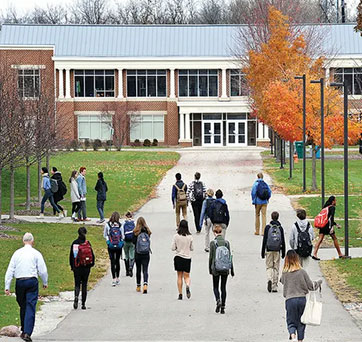 Students walking outside. Links to Gifts by Estate Note